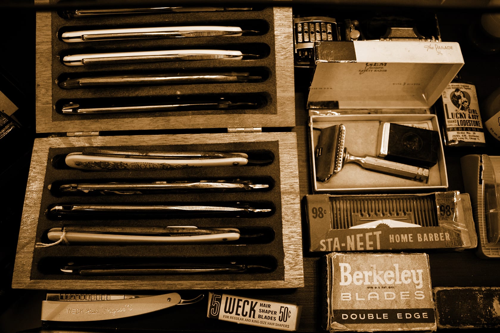 Vintage straight razors and blade tins in the Cable Car Clothiers barbershop